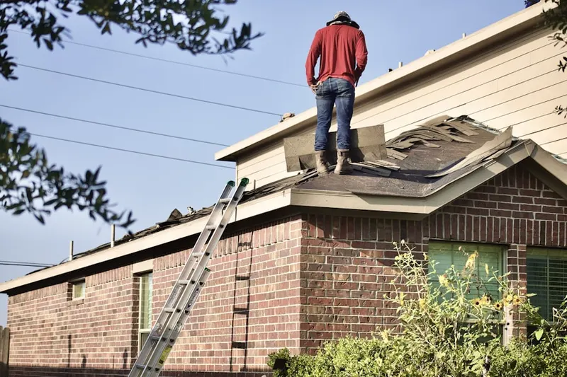 Professional roofer working on a residential roof in Leonardo